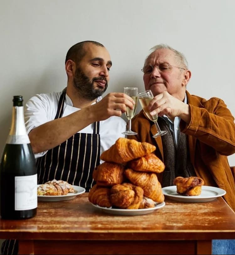 A chef sharing a celebratory moment with a guest