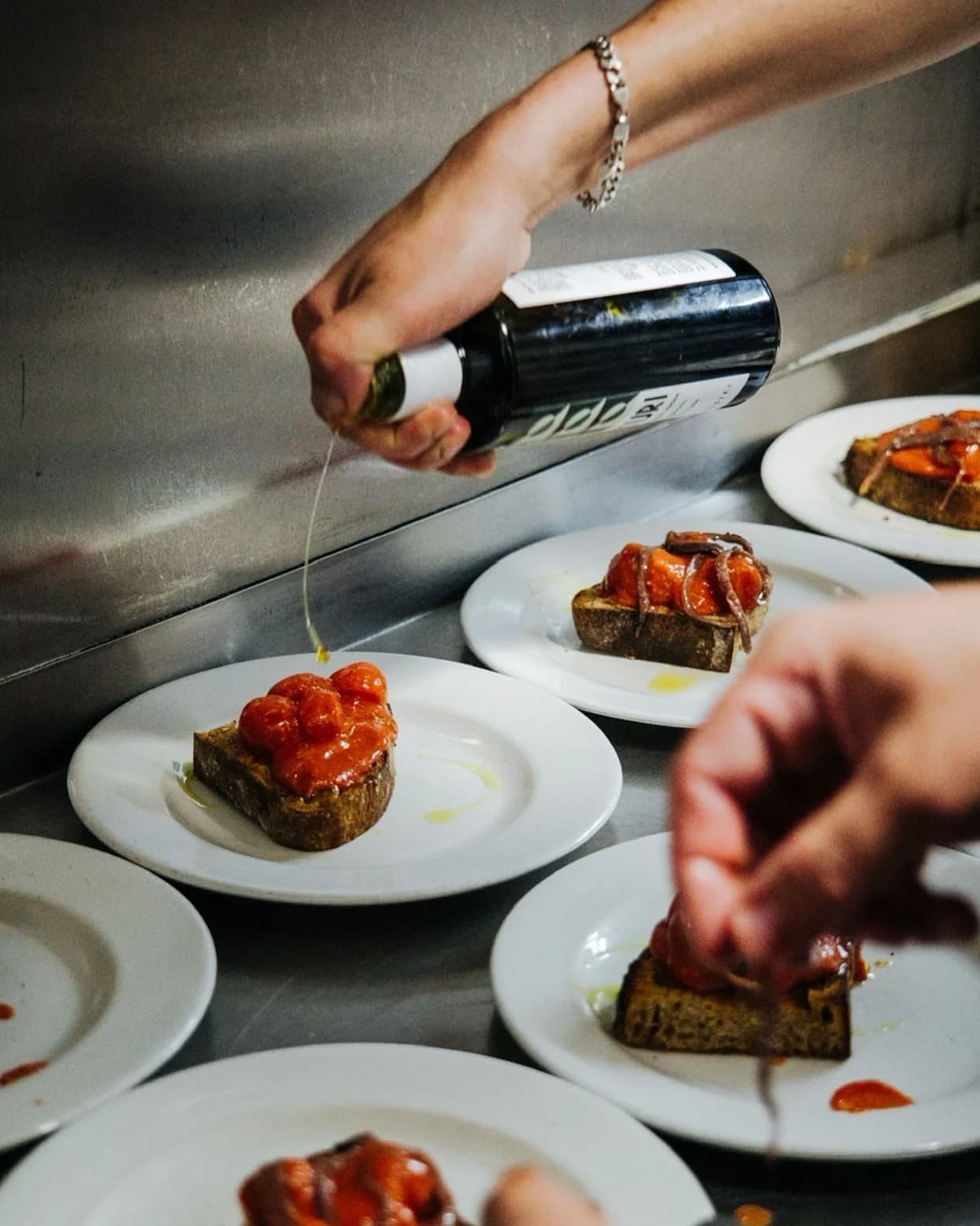 Bruschetta being finished for service